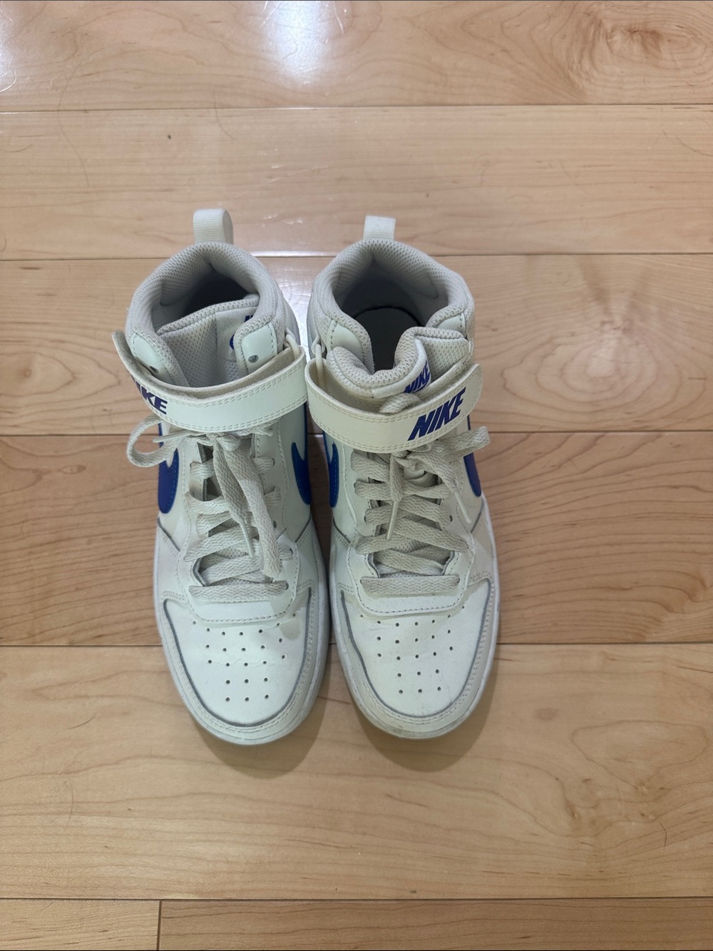 Nike Women’s High-Top Sneakers in White with Blue Swoosh